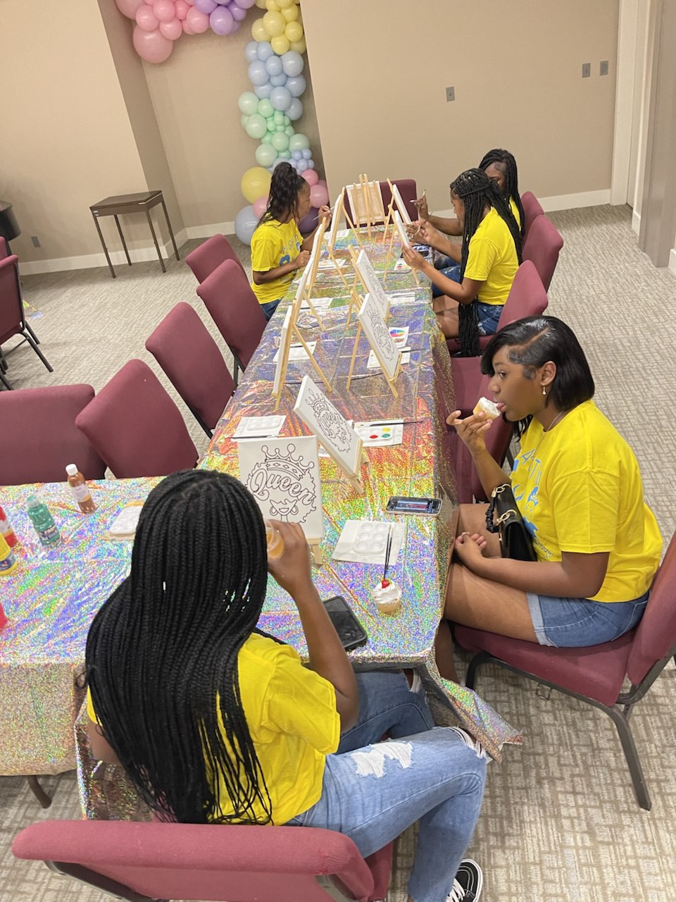 Girls participating in creative activities at Support To Live event